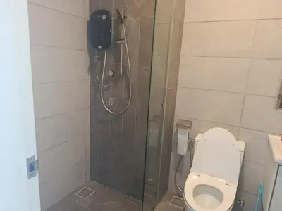 a bathroom with a shower and a toilet at Kuala Lumpur Suites Majestic Sky Pool in Kuala Lumpur