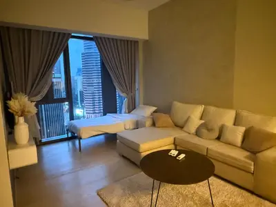 a living room with a couch and a bed at KL Star Residance KLCC by Nexus in Kuala Lumpur
