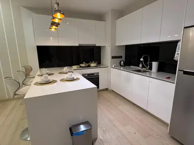 a kitchen with white cabinets and a white counter top at KL Star Residance KLCC by Nexus in Kuala Lumpur