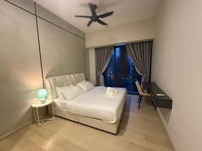 a bedroom with a white bed and a ceiling fan at KL Star Residance KLCC by Nexus in Kuala Lumpur