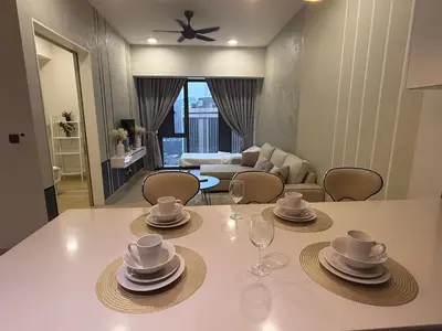 a dining table with plates and wine glasses on it at KL Star Residance KLCC by Nexus in Kuala Lumpur
