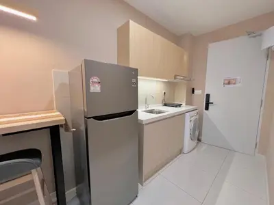 a small kitchen with a refrigerator and a sink at Majestic Residence Kuala Lumpur in Kuala Lumpur