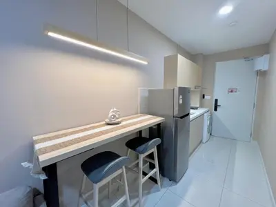 a small kitchen with a counter and a refrigerator at Majestic Residence Kuala Lumpur in Kuala Lumpur