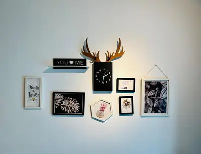 a wall with a bunch of pictures on it at Reizz Residence by Willow Trip in Kuala Lumpur