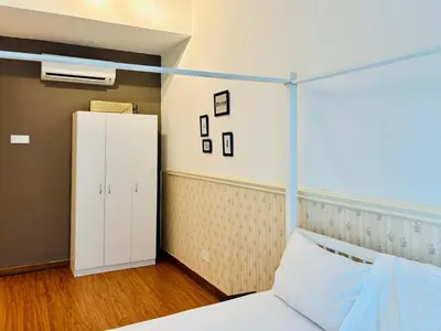 a bedroom with a bed and a white cabinet at Reizz Residence by Willow Trip in Kuala Lumpur