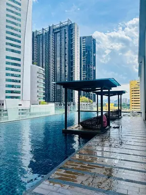 a pavilion in the middle of a body of water with buildings at Reizz Residence by Willow Trip in Kuala Lumpur