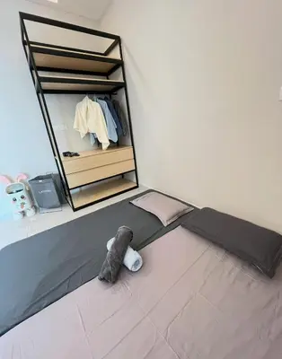 a stuffed animal sitting on a bed in a room at Parkview Serviced Apartment in Kuala Lumpur