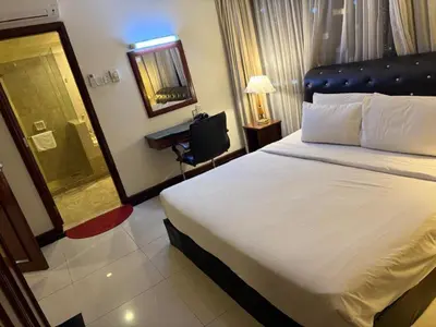 a hotel room with a bed and a desk at KL Suite at Times Square in Kuala Lumpur