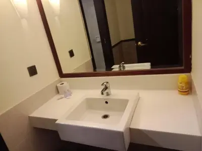 a white sink in a bathroom with a mirror at KL Suite at Times Square in Kuala Lumpur