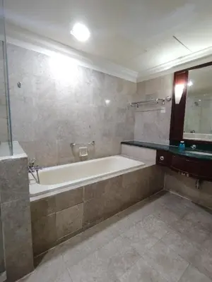 a bathroom with a bath tub and a mirror at KL Suite at Times Square in Kuala Lumpur