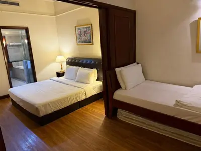 a bedroom with two beds and a mirror at KL Suite at Times Square in Kuala Lumpur