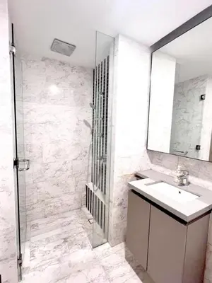 a bathroom with a shower and a sink and a mirror at Eaton Hotel \u4f0a\u987f\u9152\u5e97 \u4e94\u661f\u7ea7\u9152\u5e97 in Kuala Lumpur