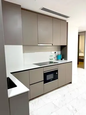 a kitchen with white cabinets and a stove top oven at Eaton Hotel \u4f0a\u987f\u9152\u5e97 \u4e94\u661f\u7ea7\u9152\u5e97 in Kuala Lumpur