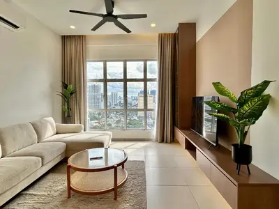 a living room with a couch and a tv at 3BR KL Sentral L27 Modern Vintage Views in Kuala Lumpur