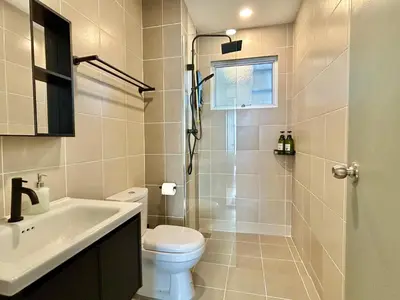 a bathroom with a shower and a toilet and a sink at 3BR KL Sentral L27 Modern Vintage Views in Kuala Lumpur