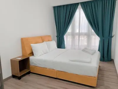 a bedroom with a bed and a window with green curtains at Agile Landmark Suites by Kuala Lampur City in Kuala Lumpur