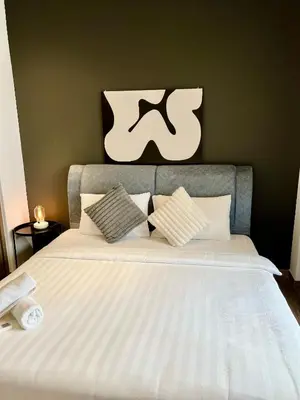 a bed with white sheets and pillows in a bedroom at Agile Landmark Suites by Kuala Lampur City in Kuala Lumpur