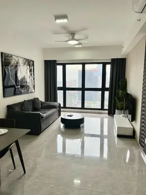 a living room with a couch and a table at Agile Landmark Suites by Kuala Lampur City in Kuala Lumpur