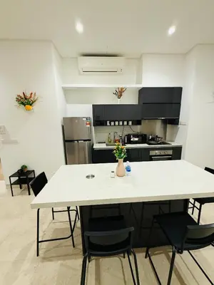 a kitchen with a large white table and chairs at Lucentia Residence Skyline KL Stay in Kuala Lumpur