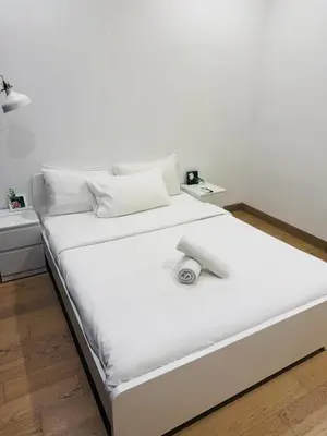 a white bed in a room with white walls at Lucentia Residence Skyline KL Stay in Kuala Lumpur