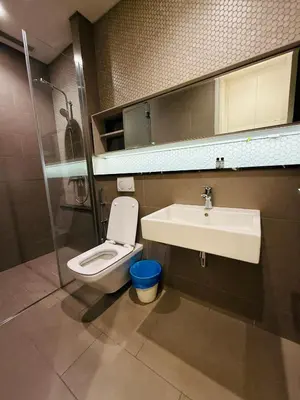 a bathroom with a sink and a toilet and a mirror at Lucentia Residence Skyline KL Stay in Kuala Lumpur