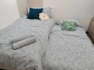 a bed with two pillows and a stuffed animal on it at Small Studio Neu Suites Gleneagles Ampang KL in Kuala Lumpur