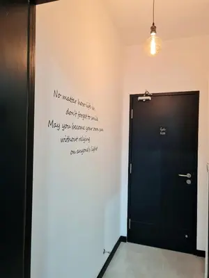 a black door with writing on the wall next to it at Small Studio Neu Suites Gleneagles Ampang KL in Kuala Lumpur