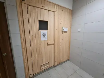 a wooden door with a sign on it in a room at Chillax Studio Near KLCC Gleneagles in Kuala Lumpur