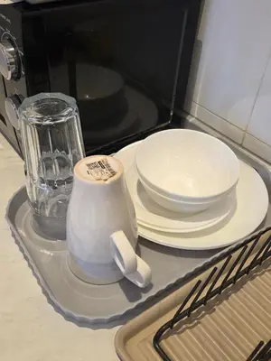 a tray with plates and a blender in a microwave at Chillax Studio Near KLCC Gleneagles in Kuala Lumpur