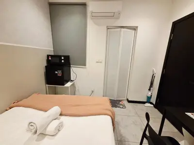 a bedroom with a bed and a television in it at Little Studio Neu Suites near KLCC in Kuala Lumpur