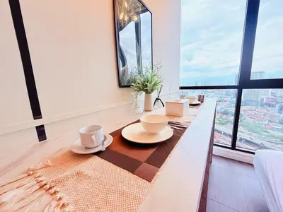 a dining room with a table with cups and plates on it at Scarletz Luxury Suites KL in Kuala Lumpur