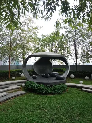 a sculpture of a vase sitting in the grass at Scarletz Suites Klcc Twin tower by Lucky in Kuala Lumpur