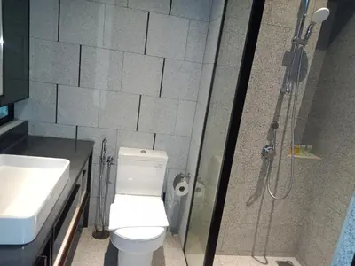 a bathroom with a shower and a toilet and a sink at Scarletz Suites Klcc Twin tower by Lucky in Kuala Lumpur