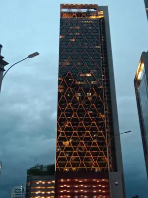 a tall building with lights on the side of it at Scarletz Suites Klcc Twin tower by Lucky in Kuala Lumpur