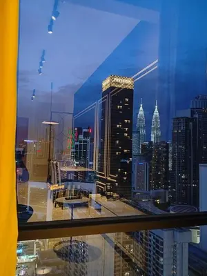 a view of a city skyline from a window at skyscraper by cozy in Kuala Lumpur