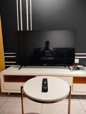a television with a remote control sitting on a table at skyscraper by cozy in Kuala Lumpur
