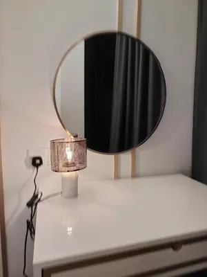 a lamp on a table with a mirror on it at skyscraper by cozy in Kuala Lumpur