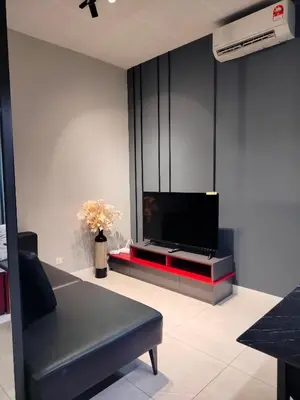 a living room with a flat screen tv on a entertainment center at skyscraper by cozy in Kuala Lumpur