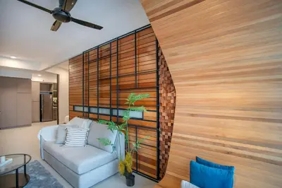 a living room with a couch and a wooden wall at Novo Ampang Residence Studio Close to KLCC and Gleneagles in Kuala Lumpur