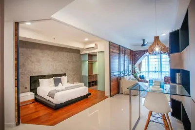 a bedroom with a bed and a glass table at Novo Ampang Residence Studio Close to KLCC and Gleneagles in Kuala Lumpur