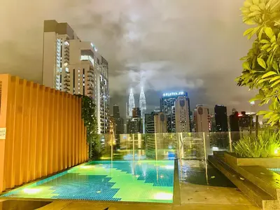 a swimming pool on top of a city skyline at Majestic Residence KLCC By Homestay in Kuala Lumpur
