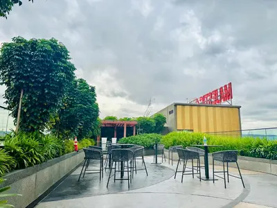 a group of tables and chairs on a patio at Majestic Residence KLCC By Homestay in Kuala Lumpur