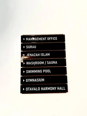 a stack of black signs on a wall at Majestic Residence KLCC By Homestay in Kuala Lumpur