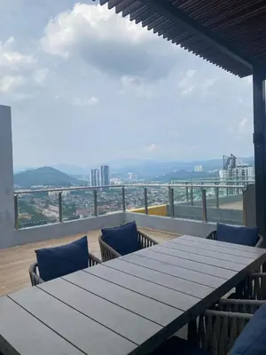 a table and chairs on a balcony with a view at Comfort Stay Neusuite Jelatek in Kuala Lumpur
