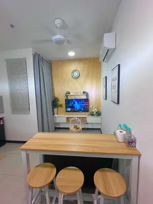 a room with a table and two chairs and a tv at Comfort Stay Neusuite Jelatek in Kuala Lumpur