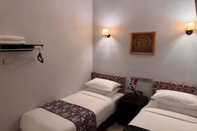 two beds in a hotel room with lights on the wall at Lofts At Hang Kasturi Kuala Lumpur in Kuala Lumpur