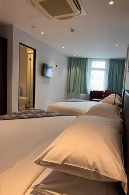 a group of four beds in a hotel room at Lofts At Hang Kasturi Kuala Lumpur in Kuala Lumpur