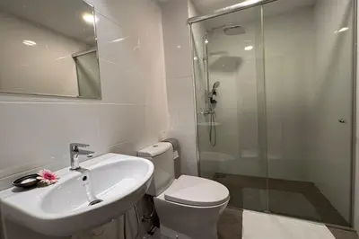 a bathroom with a toilet and a sink and a shower at Lofts At Hang Kasturi Kuala Lumpur in Kuala Lumpur