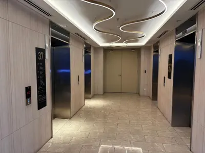 a hallway with a row of elevators in a building at The Axon Residence KLCC Suites Kuala Lumpur in Kuala Lumpur