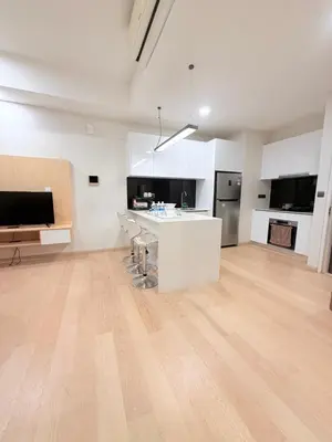 a large kitchen with white cabinets and a wooden floor at Star Residences Apartment KLCC in Kuala Lumpur